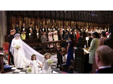 In this frame from video, Britain's Prince Harry and Meghan Markle watch as the bridesmaids and page boys walk down the aisle at their wedding ceremony at St. George's Chapel in Windsor Castle in Windsor, near London, England, Saturday, May 19, 2018.  (UK Pool/Sky News via AP) ORG XMIT: NYAG105