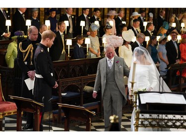 Britain's Prince Harry looks at his bride, Meghan Markle, as she arrives accompanied by the Prince Charles during the wedding ceremony of Prince Harry and Meghan Markle at St. George's Chapel in Windsor Castle in Windsor, near London, England, Saturday, May 19, 2018. (Jonathan Brady/pool photo via AP) ORG XMIT: RWW178