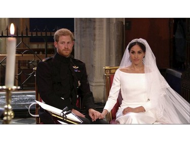 In this frame from video, Britain's Prince Harry and Meghan Markle listen at their wedding ceremony at St. George's Chapel in Windsor Castle in Windsor, near London, England, Saturday, May 19, 2018.  (UK Pool/Sky News via AP) ORG XMIT: NYAG109