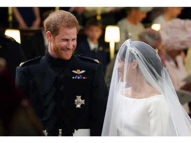 Britain's Prince Harry looks at his bride, Meghan Markle, during their wedding ceremony at St. George's Chapel in Windsor Castle in Windsor, near London, England, Saturday, May 19, 2018. (Gareth Fuller/pool photo via AP) ORG XMIT: RWW845