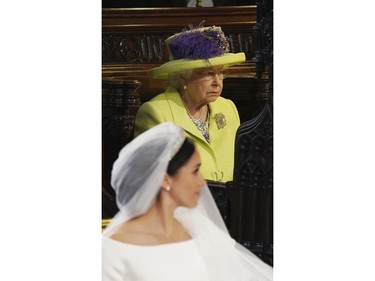 Britain's Queen Elizabeth looks on during the wedding of Prince Harry and Meghan Markle, front, at St. George's Chapel in Windsor Castle in Windsor, near London, England, Saturday, May 19, 2018. (Jonathan Brady/pool photo via AP) ORG XMIT: RWW187