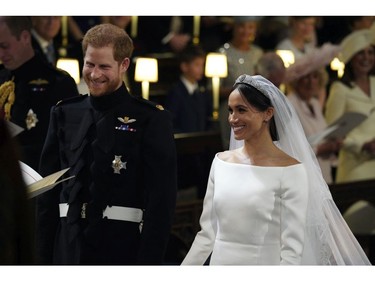 Britain's Prince Harry and Meghan Markle smile during their wedding ceremony in St. George's Chapel in Windsor Castle in Windsor, near London, England, Saturday, May 19, 2018. (Jonathan Brady/pool photo via AP) ORG XMIT: RWW188