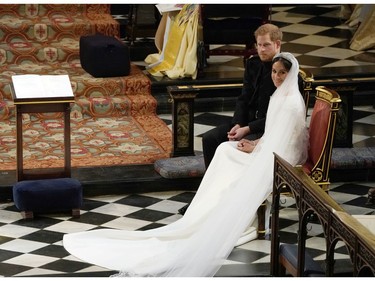 Britain's Prince Harry and Meghan Markle during their wedding at St. George's Chapel in Windsor Castle in Windsor, near London, England, Saturday, May 19, 2018. (Owen Humphreys/pool photo via AP) ORG XMIT: RWW194