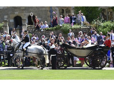 Prince Harry and Meghan Markle leave after their wedding ceremony at St. George's Chapel in Windsor Castle in Windsor, near London, England, Saturday, May 19, 2018. (Ian West/pool photo via AP) ORG XMIT: RWW212