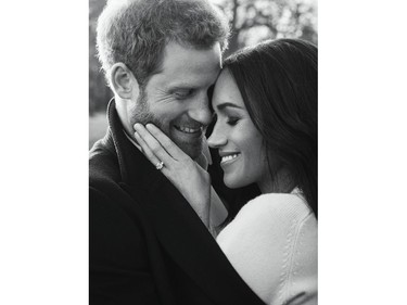 In this photo released by Kensington Palace on Thursday, Dec. 21, 2017, Britain's Prince Harry and Meghan Markle pose for one of two official engagement photos, at Frogmore House, in Windsor, England.