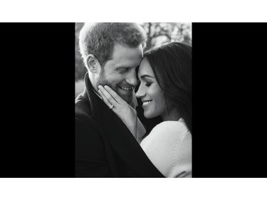 In this photo released by Kensington Palace on Thursday, Dec. 21, 2017, Britain's Prince Harry and Meghan Markle pose for one of two official engagement photos, at Frogmore House, in Windsor, England.