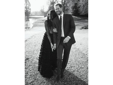In this photo released by Kensington Palace on Thursday, Dec. 21, 2017, Britain's Prince Harry and Meghan Markle pose an official engagement photo, at Frogmore House, in Windsor, England.