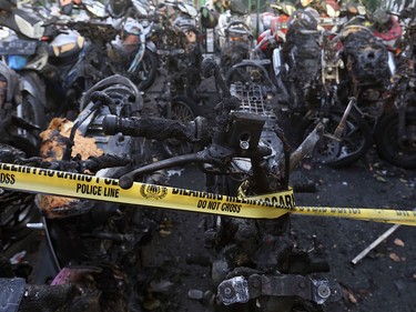 Burnt motorcycles are seen at one of the sites of the church attacks in Surabaya, East Java, Indonesia, Sunday, May 13, 2018.