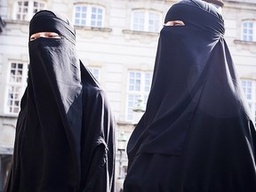 Women in niqab walk in front of the Danish Parliament at Christiansborg Castle, in Copenhagen, Denmark, Thursday May 31. 2018. (AP)