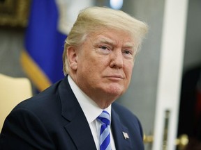 In this May 16, 2018 file photo, President Donald Trump listens to a question during a meeting in the Oval Office of the White House in Washington.