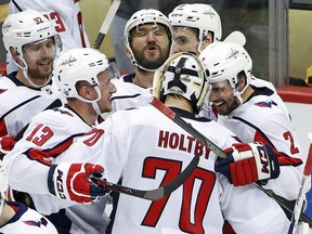 In this May 7, 2018, file photo, Washington Capitals goaltender Braden Holtby (70) celebrates with Evgeny Kuznetsov (92), Jakub Vrana (13), Alex Ovechkin, top centre, and Matt Niskanen (2) in Pittsburgh. (AP Photo/Gene J. Puskar, File)