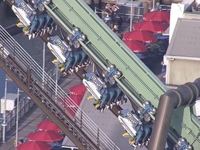 In this screenshot, riders on the "Flying Dinosaur" roller coaster at Universal Studios Japan wait for rescue after a malfunction on May 1, 2018 in Osaka, Japan.