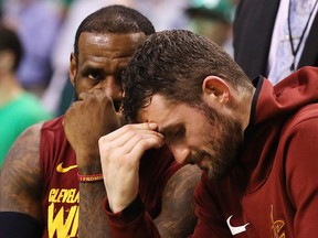 LeBron James and Kevin Love of the Cleveland Cavaliers react on the bench at TD Garden on May 15, 2018 in Boston. (Maddie Meyer/Getty Images)