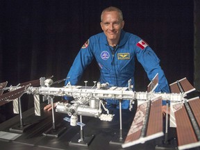 Canadian astronaut David Saint-Jacques looks at a model of the International Space Station at the Canadian Space Agency headquarters in Saint Hubert, Que. on Wednesday, November 29, 2017.