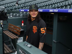 San Francisco Giants pitcher Dereck Rodriguez walks up the dugout stairs and onto the warning track of Coors Field as he warms up before a game against the Colorado Rockies, Monday, May 28, 2018, in Denver.