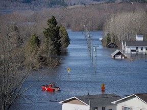 A Canadian Cost Guard craft heads across a flooded area at Darlings Island, N.B. on May 5, 2018. (The Canadian Press/Andrew Vaughan)