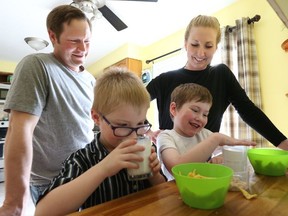 The Larocque family from Tottenham Ontario (L-R) Little Lucy, dad Jamie, Joshua aged 5 1/2 (blue shirt), Andre aged 8 (white shirt) and mom Sasha give the boys their medicine to combat their cystic fibrosis (CF). Andre won a "trial drug" lottery and is on a special medicine, but Joshua but their parents want the government to make the lottery drugs readily available, on Friday May 4, 2018.