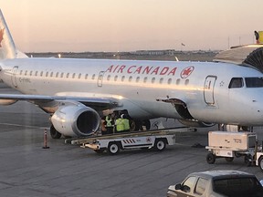 Crews work on the tarmac after a raccoon got into a Air Canada in Saskatoon on May 3, 2018.