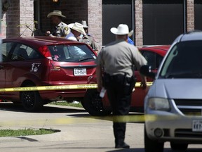 Denton County Sheriff's officers investigate a crime scene where multiple people were killed and one was hospitalized after a shooting at a home in Ponder, Texas on Wednesday, May 16, 2018.