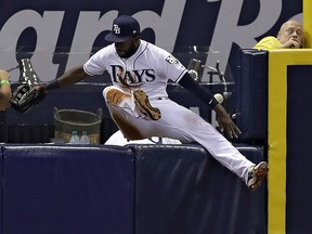 Tampa Bay Rays left fielder Denard Span (2) goes over the wall chasing a foul ball Thursday, May 24, 2018, in St. Petersburg, Fla. (AP Photo/Chris O'Meara)