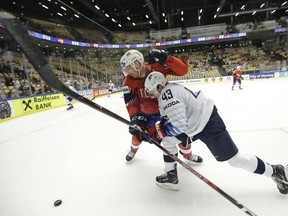 Norway's Anders Bastiansen, left, challenges for the puck with Quinn Hughes, right, of the United States during the Ice Hockey World Championships group B match between Norway and the United States at the Jyske Bank Boxen arena in Herning, Denmark, Sunday, May 13, 2018.