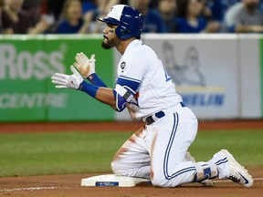 Toronto Blue Jays' Devon Travis reacts after hitting a triple during seventh inning AL baseball action against the Boston Red Sox in Toronto on April 26, 2018