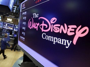 In this Monday, Aug. 7, 2017, file photo, The Walt Disney Co. logo appears on a screen above the floor of the New York Stock Exchange. Disney is seeking new frontiers. The media company launched its $5-a-month sports streaming service, ESPN Plus, in April 2018, and it signed a deal with Twitter a month later to create Marvel, ABC and ESPN content on that service. Meanwhile, Disney is trying to buy much of 21st Century Fox, including the Fox television network and the X-Men movie franchise.