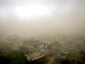 Village Itada is enveloped in thick blanket of dust during a dust storm in Noida near New Delhi, India, Sunday, May 13, 2018.