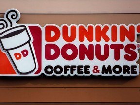 This Jan. 22, 2018, file photo shows a Dunkin' Donuts logo on a shop in Mount Lebanon, Pa.