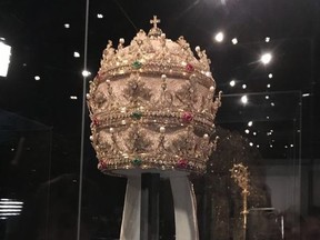 In a May 5, 2018 photo, a jewel-encrusted papal tiara from the Sistine Chapel sacristy at the Vatican, is displayed at the Metropolitan Museum of Art in its "Heavenly Bodies: Fashion and the Catholic Imagination," the spring fashion exhibit at the museum's Costume Institute.