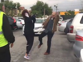 A video circulating on social media shows an elderly man fighting a woman in a parking lot. (Twitter/EnriqueConde1)