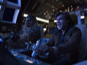 In this image released by Lucasfilm, Alden Ehrenreich, right, and Joonas Suotamo appear in a scene from "Solo: A Star Wars Story." (Jonathan Olley/Lucasfilm via AP)