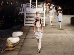 A model presents a creation during Chanel's Cruise 2018/2019 fashion collection presented in Paris, Thursday, May 3, 2018.
