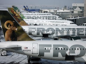 In this Feb. 22, 2010 file photo, Frontier Airlines jetliners sit stacked up at gates along the A concourse at Denver International Airport. (AP Photo/David Zalubowski, File)