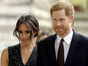 FILE - In this Monday, April 23, 2018 file photo, Britain's Prince Harry and his fiancee Meghan Markle arrive to attend a Memorial Service to commemorate the 25th anniversary of the murder of black teenager Stephen Lawrence at St Martin-in-the-Fields church in London.