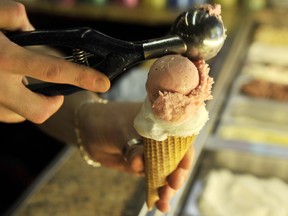 An ice cream dealer prepares a cone in the western German city of Duisburg on August 20, 2009. (No Udder Ice Cream not pictured)