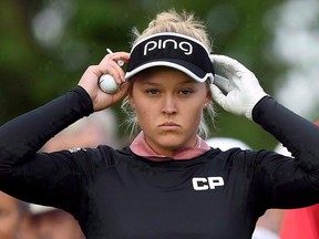 Brooke Henderson adjusts her visor at the first hole during the 2017 CP Women's Open of the LPGA Tour, in Ottawa on Thursday, Aug. 24, 2017. (The Canadian Press/Sean Kilpatrick)