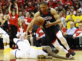 Eric Gordon of the Houston Rockets steals from Draymond Green #23 of the Golden State Warriors late in the fourth quater of Game 5 of the Western Conference finals of the 2018 NBA Playoffs at Toyota Center on May 24, 2018