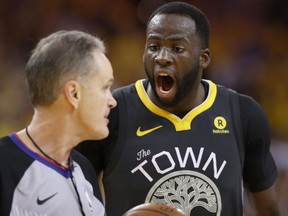 Draymond Green of the Golden State Warriors complains to Mike Callahan during Game 2 against the New Orleans Pelicans at ORACLE Arena on May 1, 2018