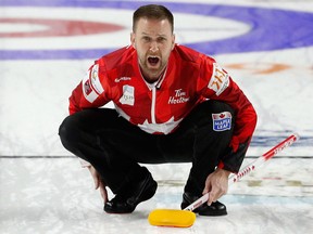 Canada skip Brad Gushue directs sweepers during a qualification game against the United States during the World Men's Curling Championship on April 7, 2018