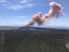 In this photo provided by the U.S. Geological Survey, red ash rises from the Puu Oo vent on Hawaii's Kilauea Volcano after a magnitude-5.0 earthquake struck the Big Island, Thursday, May 3, 2018 in Hawaii Volcanoes National Park. (Kevan Kamibayashi/U.S. Geological Survey via AP)