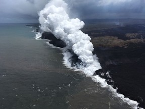 In this Saturday, May 26, 2018 image from video released by the U.S. Geological Survey, lava sends up clouds of steam and toxic gases as it enters the Pacific Ocean as Kilauea Volcano continues its eruption cycle near Pahoa on the island of Kilauea, Hawaii. (U.S. Geological Survey via AP)