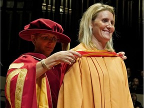 Canadian hockey player Hayley Wickenheiser (right) received an honorary diploma from Dr. Jodi Abbott (left), President & CEO of NorQuest College) in Edmonton on May 24, 2018.