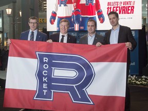 Montreal Canadiens GM Marc Bergevin, left, Laval Mayor Marc Demers, 2nd left, Canadiens owner Geoff Molson and Place Bell President Vincent Lucier, right, unveil the logo for their farm team, the Laval Rocket of the AHL, at a news conference on January 31, 2017. (The Canadian Press/Ryan Remiorz)