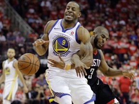 Golden State Warriors forward Andre Iguodala is fouled by Houston Rockets guard Chris Paul during the second half of Game 1 on May 14, 2018