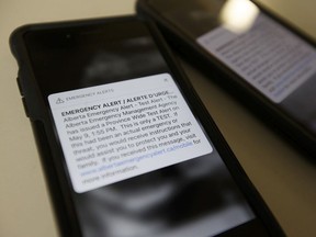 Photo of two Apple iPhones receiving the May 9, 2018 emergency alert test from the Alberta Emergency Management Agency at the Edmonton Journal in Edmonton, on Wednesday, May 9, 2018.