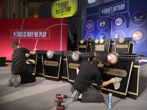 Stage hands prepare the set for the NBA basketball draft lottery Tuesday, May 15, 2018, in Chicago.