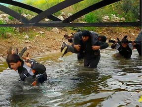 In this photo released on April 30, 2015 by a militant website, which has been verified and is consistent with other AP reporting, new recruits of the Islamic State train in Mosul, northern Iraq. (Militant website via AP)