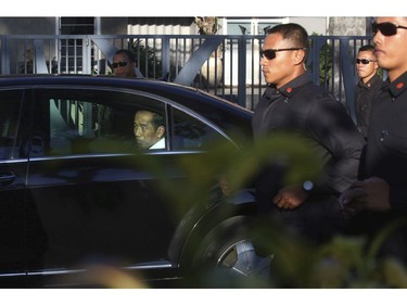 Indonesian President Joko Widodo is seen in his car after visiting one of the church attacks in Surabaya, East Java, Indonesia, Sunday, May 13, 2018.