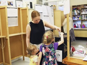 A woman casts her vote in the referendum on the 8th Amendment of the Irish Constitution, in Dublin, Ireland, Friday May 25, 2018.